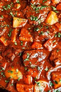 Classic beef stew with tender beef, potatoes, carrots, and rich glossy gravy, finished with fresh parsley.
