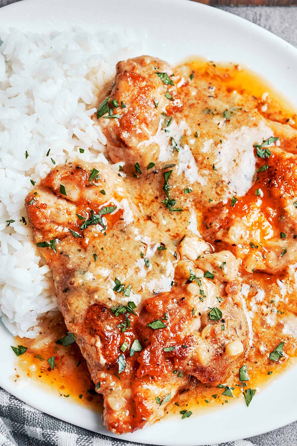 Creamy chicken without cream served with fluffy white rice and garlic Parmesan sauce.