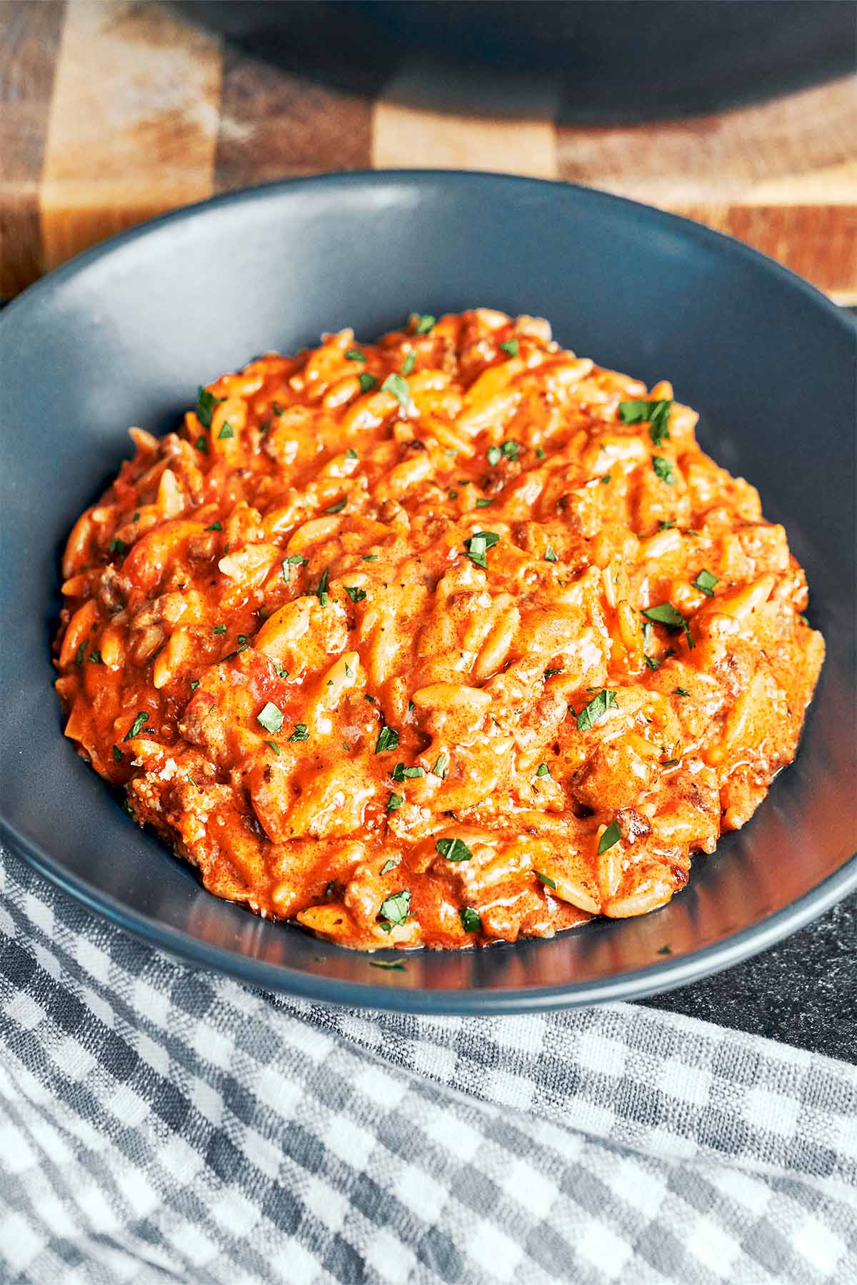 Close-up of creamy ground beef orzo showing tender orzo pasta coated in a rich tomato-cream sauce.