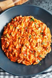 Creamy ground beef orzo served in a bowl with rich tomato-cream sauce, Parmesan, and fresh parsley.
