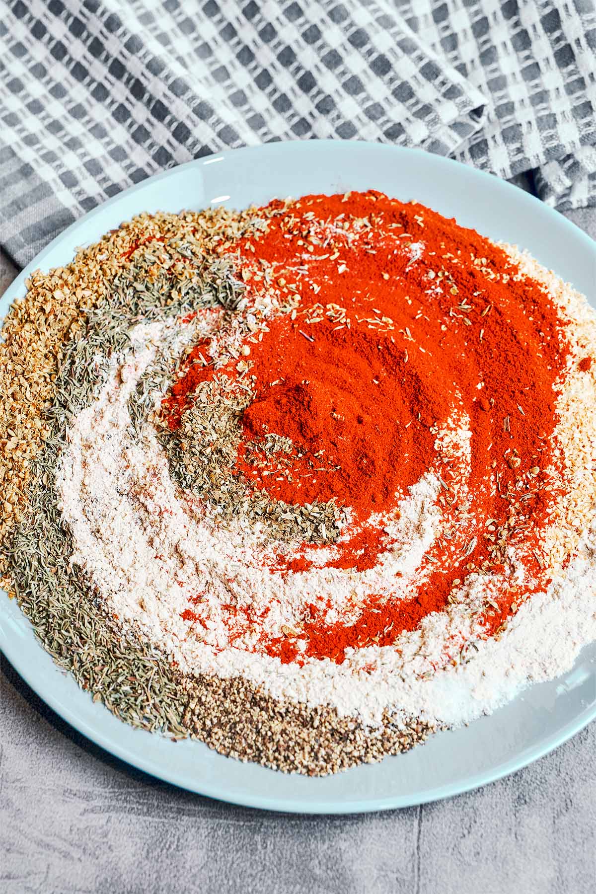 Homemade Cajun seasoning spices being mixed together.