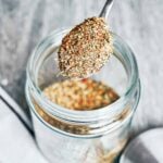italian seasoning blend in jar with spoon overhead view