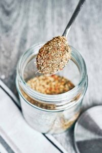 italian seasoning blend in jar with spoon overhead view