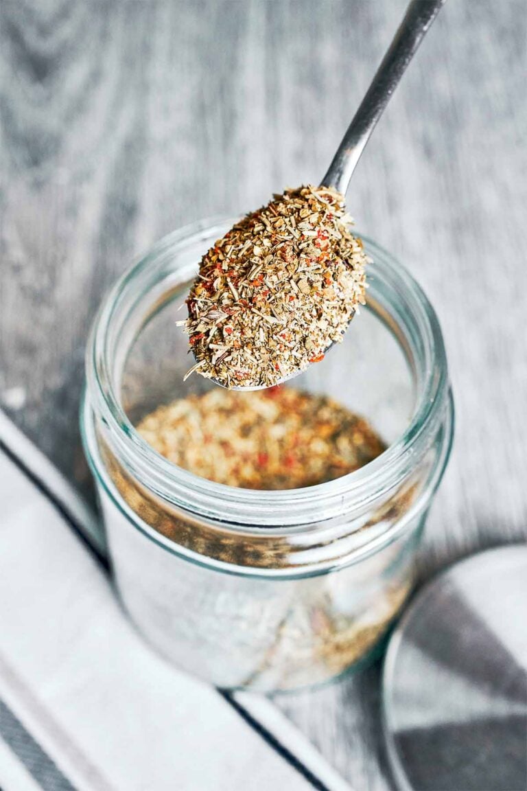 italian seasoning blend in jar with spoon overhead view