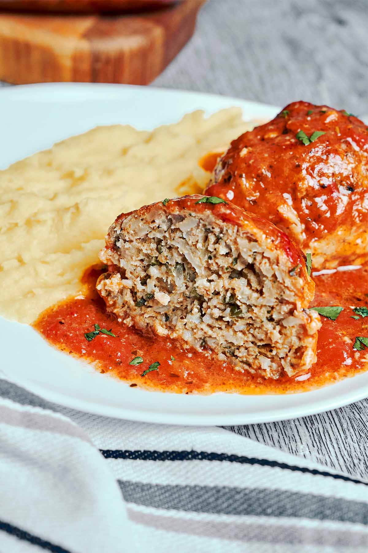 Soft and juicy baked meatball served with creamy mashed potatoes and rich tomato sauce