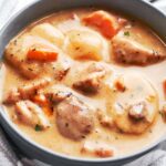 Creamy chicken cheddar potato chowder served in a bowl with tender chicken, potatoes, carrots, and bacon