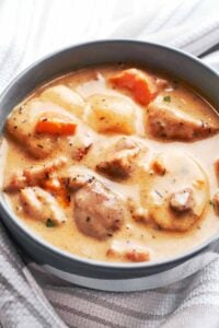 Creamy chicken cheddar potato chowder served in a bowl with tender chicken, potatoes, carrots, and bacon