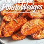 Crispy oven roasted potato wedges with smoky garlic seasoning and rosemary served on a white platter
