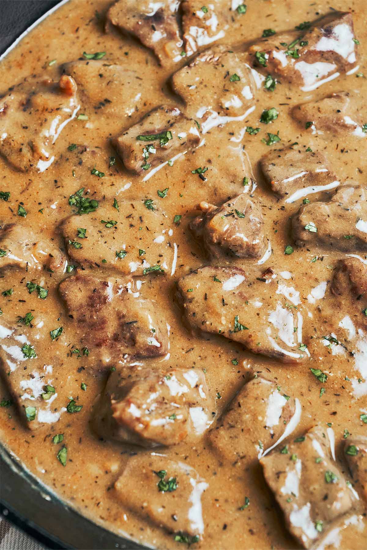 Tender pieces of beef coated in a glossy homemade brown gravy with fresh parsley