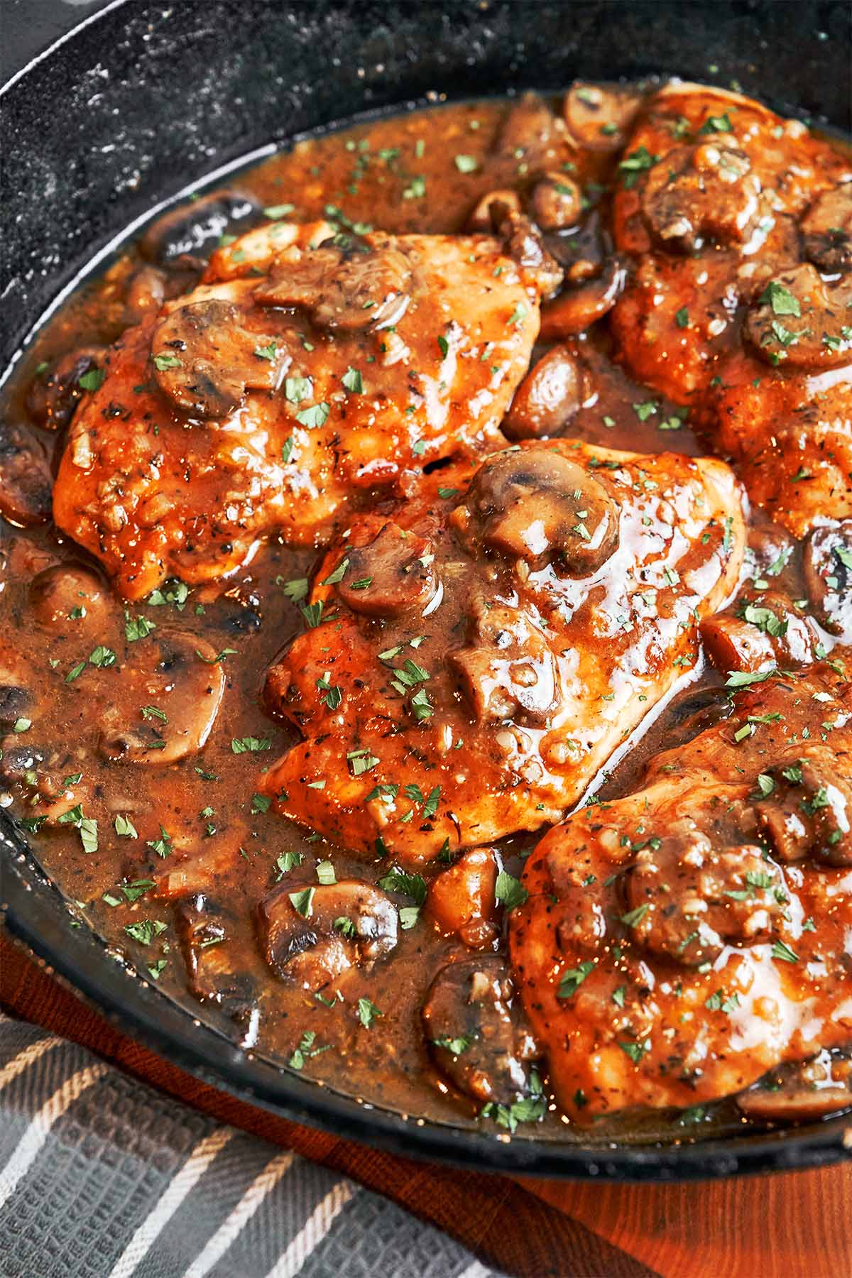Pan-seared chicken in a glossy mushroom Marsala sauce finished with fresh parsley