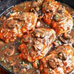 Chicken Marsala with Mushrooms close up with tender chicken cutlets, glossy Marsala sauce, golden mushrooms, and fresh parsley