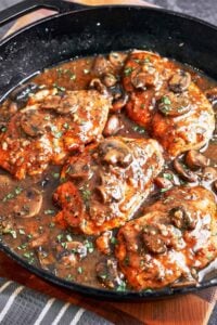 Chicken Marsala with Mushrooms close up with tender chicken cutlets, glossy Marsala sauce, golden mushrooms, and fresh parsley