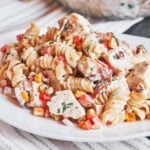 Chicken Pasta Salad with Bacon piled onto a plate with creamy fusilli, tender chicken, sweet corn, and crisp red pepper