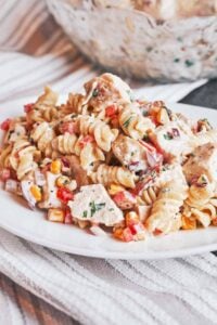 Chicken Pasta Salad with Bacon piled onto a plate with creamy fusilli, tender chicken, sweet corn, and crisp red pepper