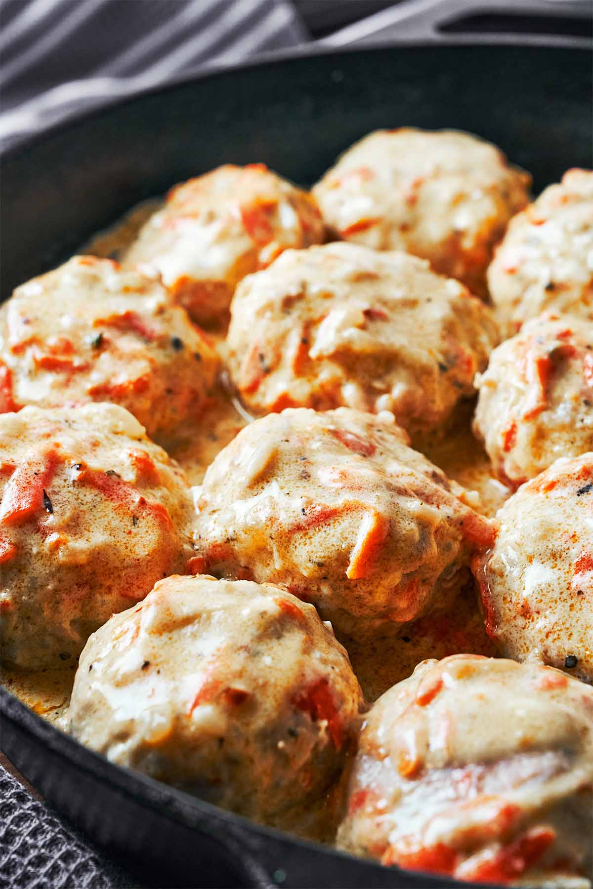 Tender chicken meatballs coated in a creamy white sauce