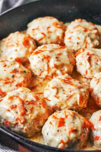 Homemade chicken meatballs simmered in a cozy white sauce with carrot and onion