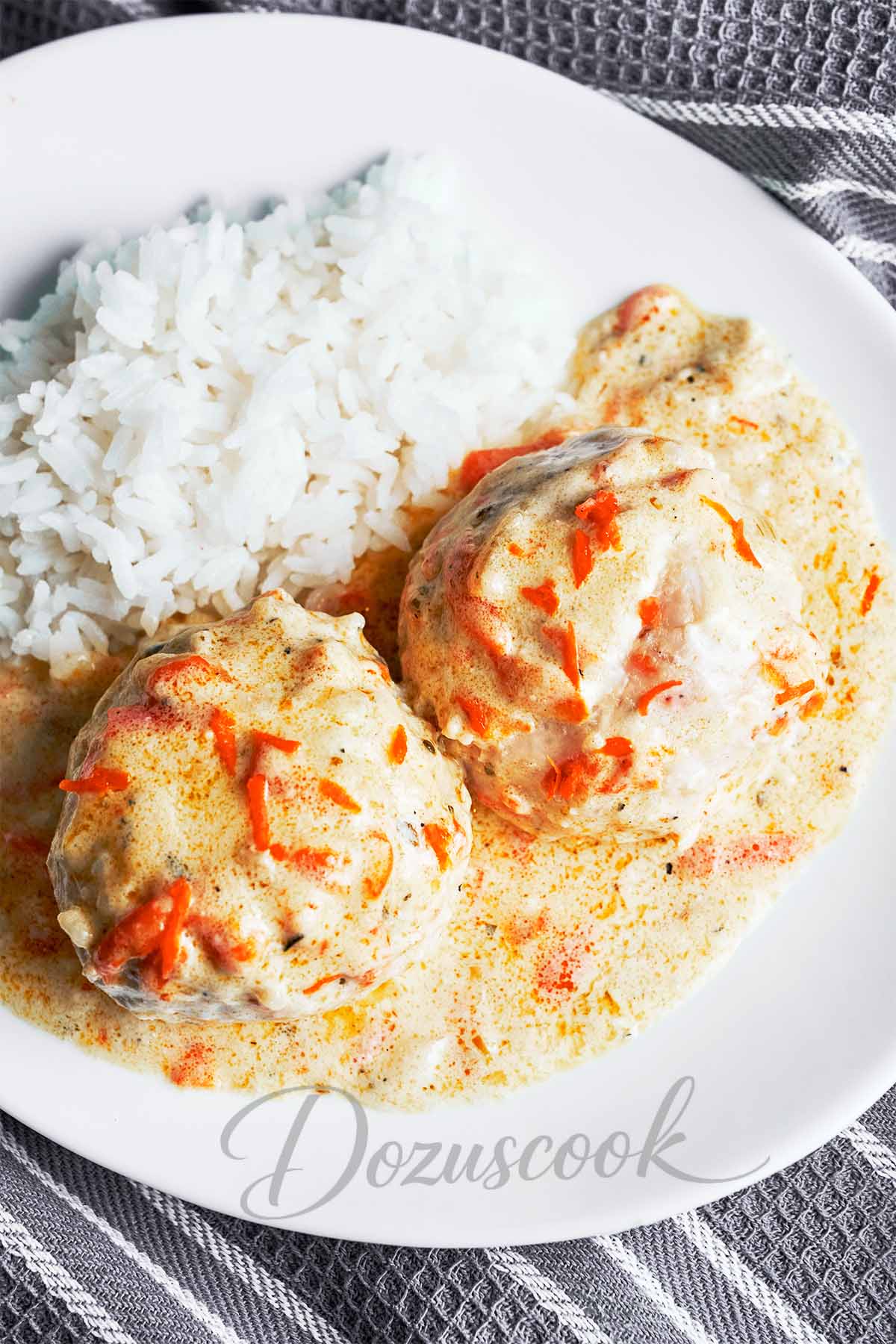 Chicken meatballs in white sauce served with fluffy rice