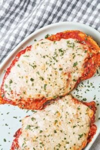 Crispy Chicken Parmesan with golden breaded chicken, rich tomato sauce, melted mozzarella, and fresh parsley.