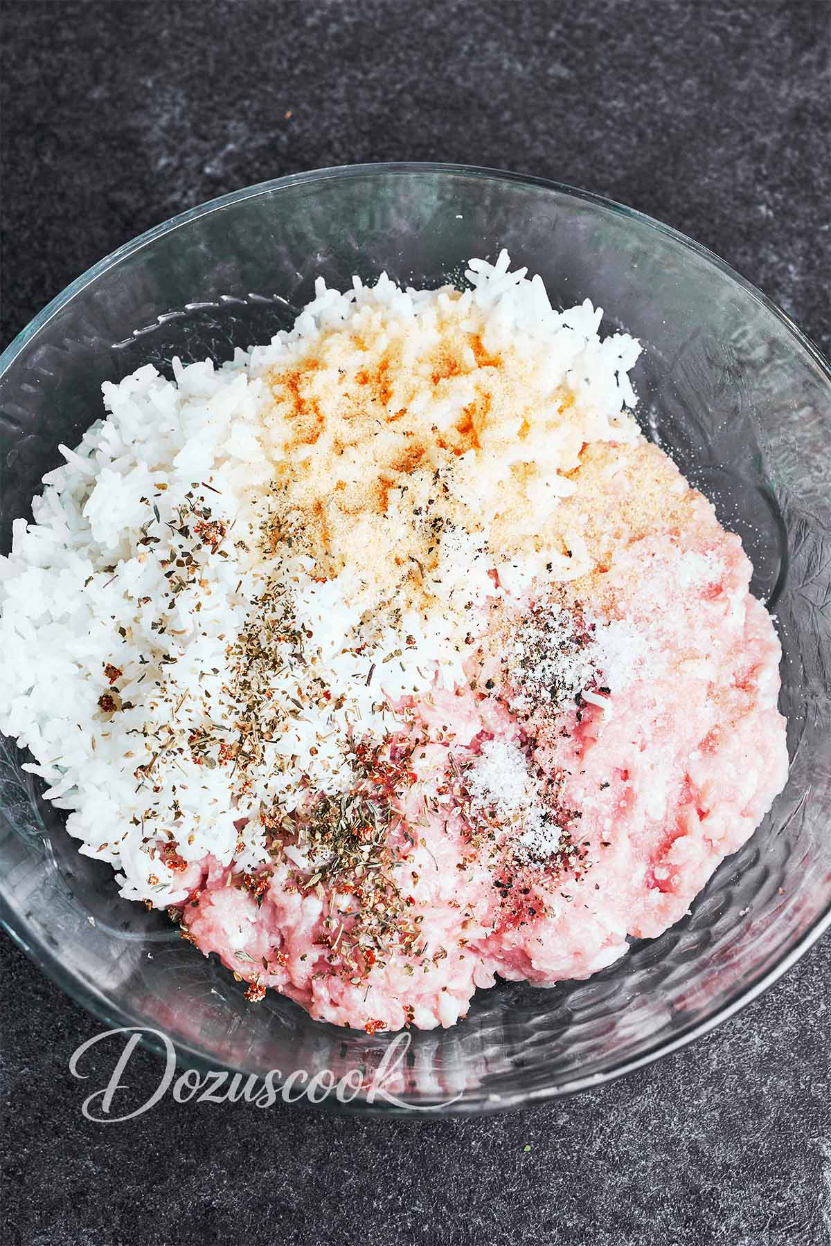 Ground chicken, cooked rice, and simple seasonings ready to mix for tender meatballs