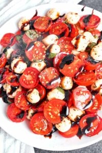 Caprese Salad with juicy cherry tomatoes, fresh mozzarella, basil, and a glossy balsamic glaze