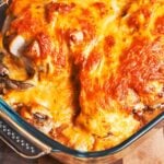 Easy baked chicken breast with a deeply golden cheese topping, mushrooms, and tender potatoes baked underneath.