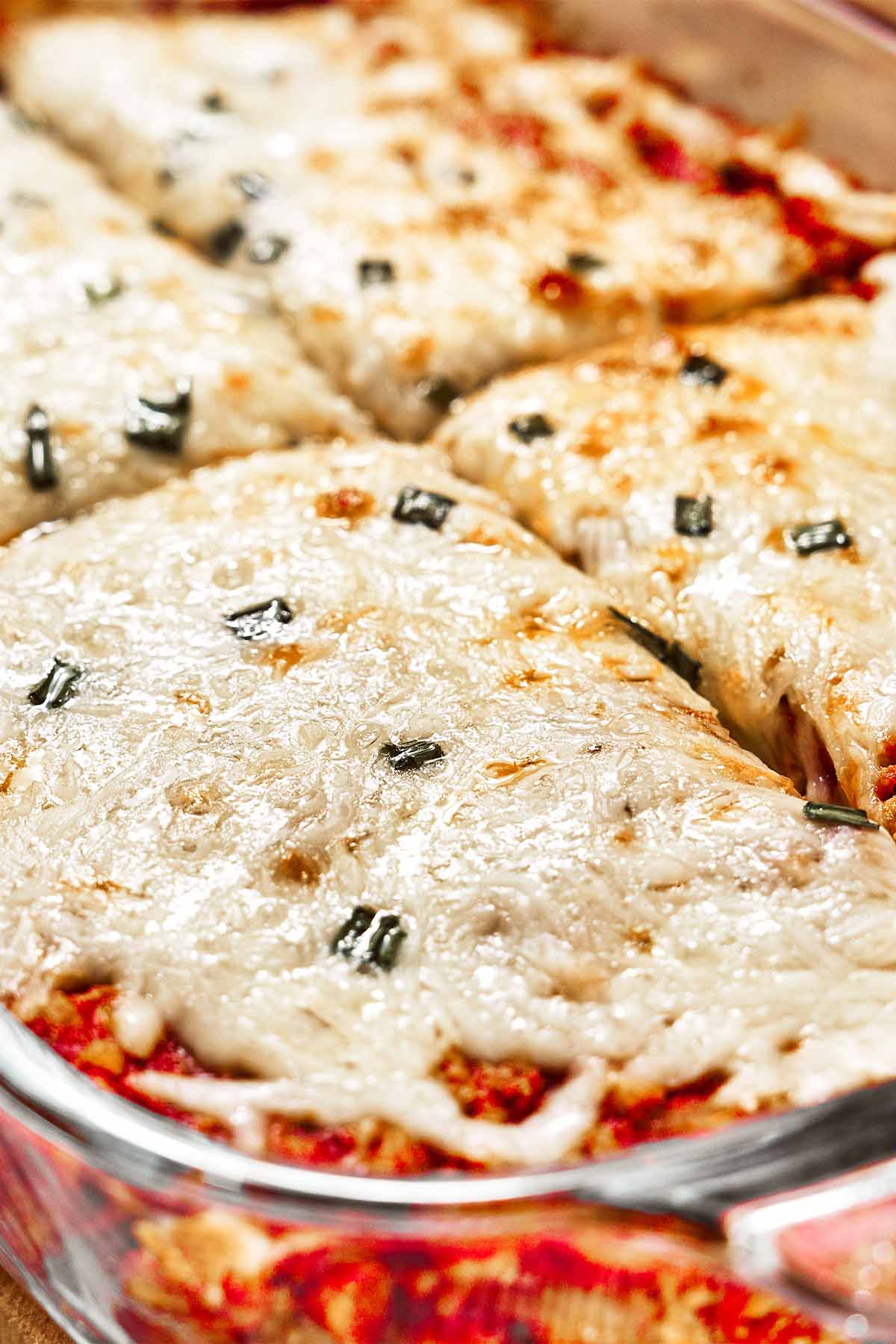 Freshly baked casserole with a bubbling layer of melted mozzarella over the rich tomato beef and potatoes underneath.