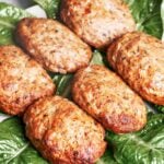 Juicy Baked Beef Patties with golden browned edges served over fresh green lettuce