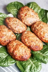 Juicy Baked Beef Patties with golden browned edges served over fresh green lettuce