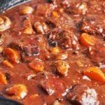 Pork Bourguignon with tender pork, carrots, and mushrooms in a rich, glossy red wine sauce.