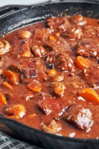 Pork Bourguignon with tender pork, carrots, and mushrooms in a rich, glossy red wine sauce.