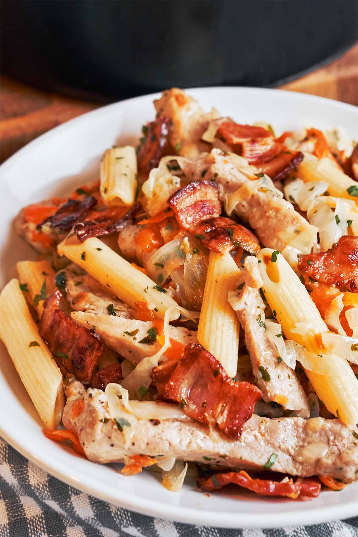 Pork and cabbage pasta with tender pork shoulder, smoky bacon, and penne piled into a cozy serving bowl