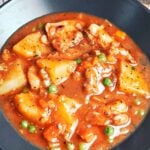 Chicken Stew with Potatoes in a rich savory sauce with tender chicken, carrots, peas, and soft golden potato chunks.
