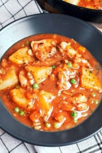 Chicken Stew with Potatoes in a rich savory sauce with tender chicken, carrots, peas, and soft golden potato chunks.