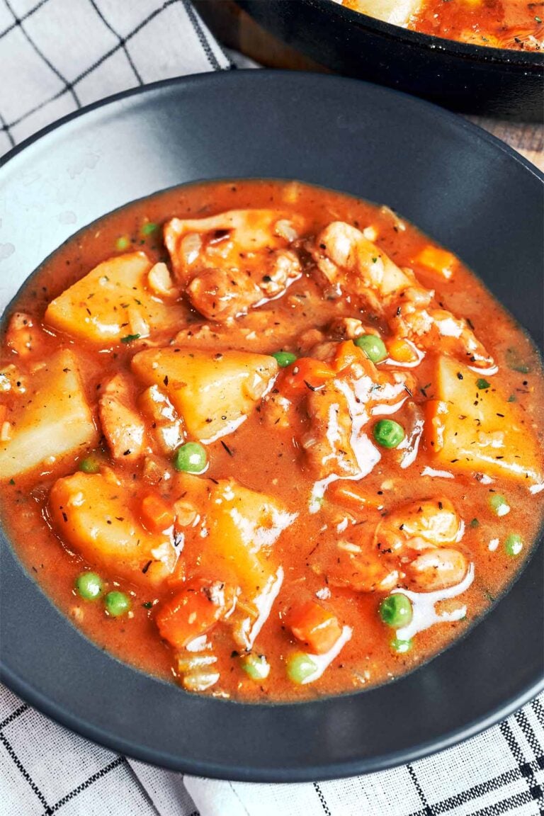 Chicken Stew with Potatoes in a rich savory sauce with tender chicken, carrots, peas, and soft golden potato chunks.