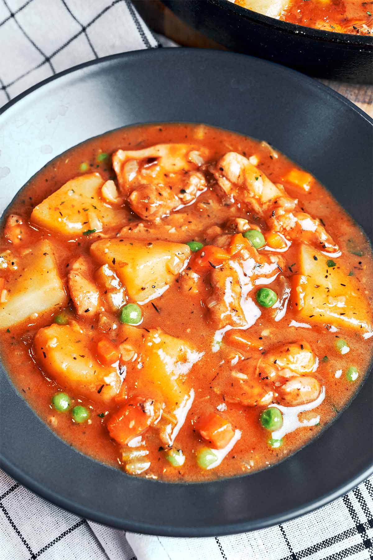 Chicken Stew with Potatoes in a rich savory sauce with tender chicken, carrots, peas, and soft golden potato chunks.