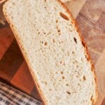 Homemade bread sliced open to show the soft, airy crumb and golden crust