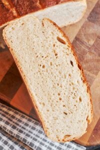 Homemade bread sliced open to show the soft, airy crumb and golden crust