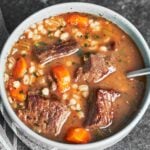 Beef barley soup served in a warm bowl with tender beef, chewy pearl barley, carrots, and a rich savory broth