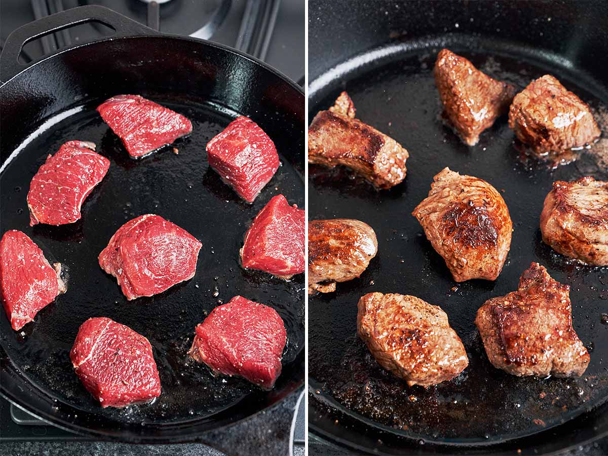 Beef cubes searing in a hot cast-iron skillet until deeply browned and caramelized on the outside