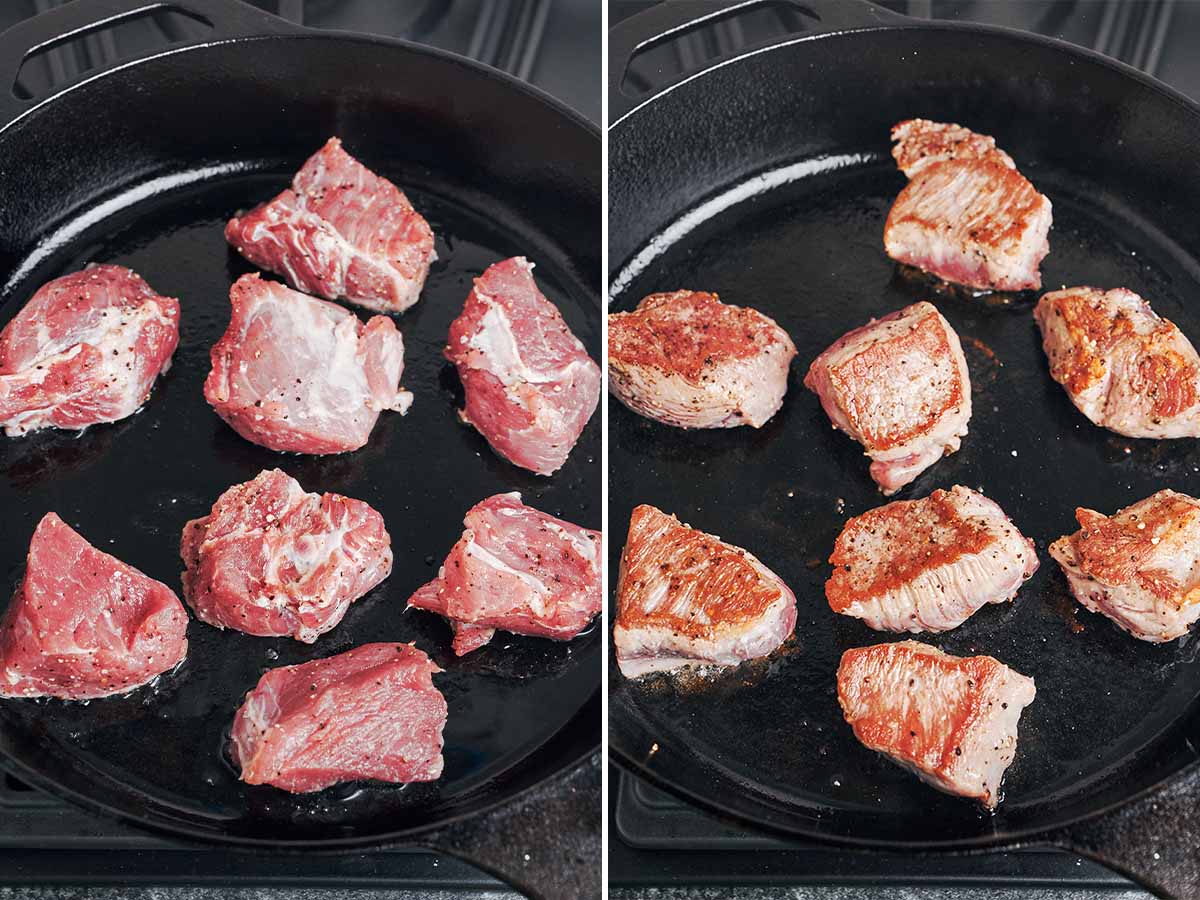 Pork shoulder pieces searing in a cast-iron skillet, with a golden-brown crust forming as they’re turned.
